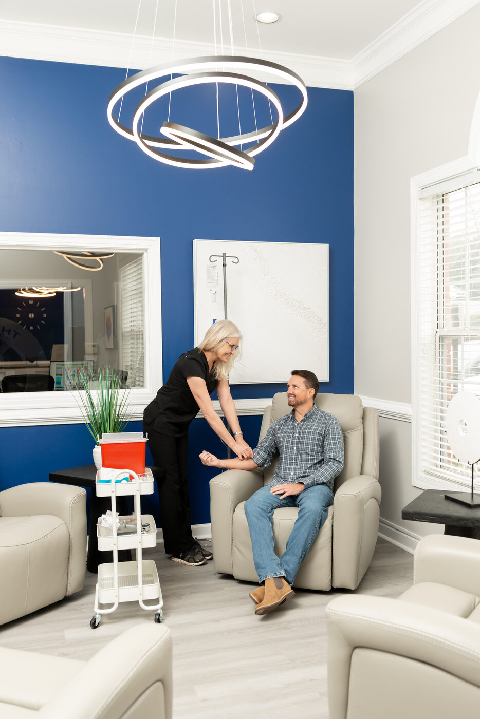 IV therapy suite at THRIVE Peak Performance — nurse with patient in treatment room