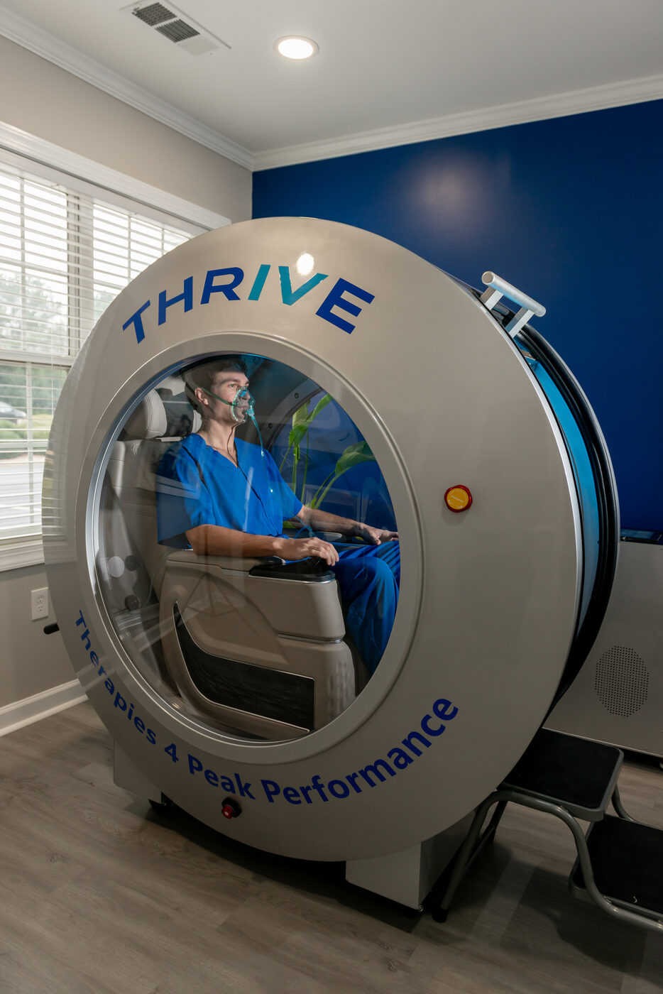 THRIVE-branded hyperbaric oxygen therapy chamber with patient inside in Alpharetta GA