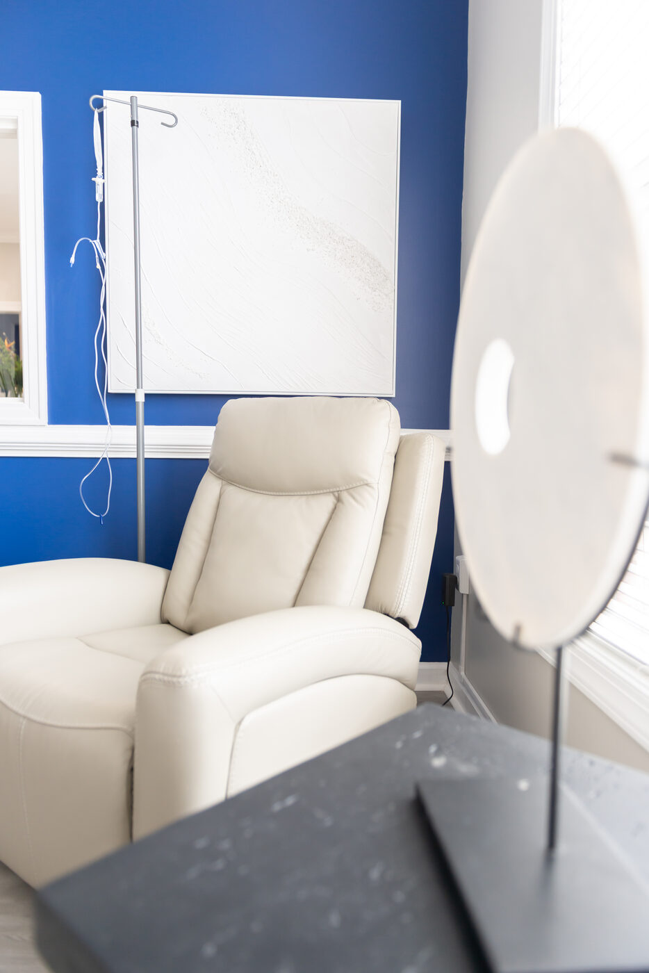 IV therapy infusion room with recliner chair and IV stand at THRIVE Peak Performance