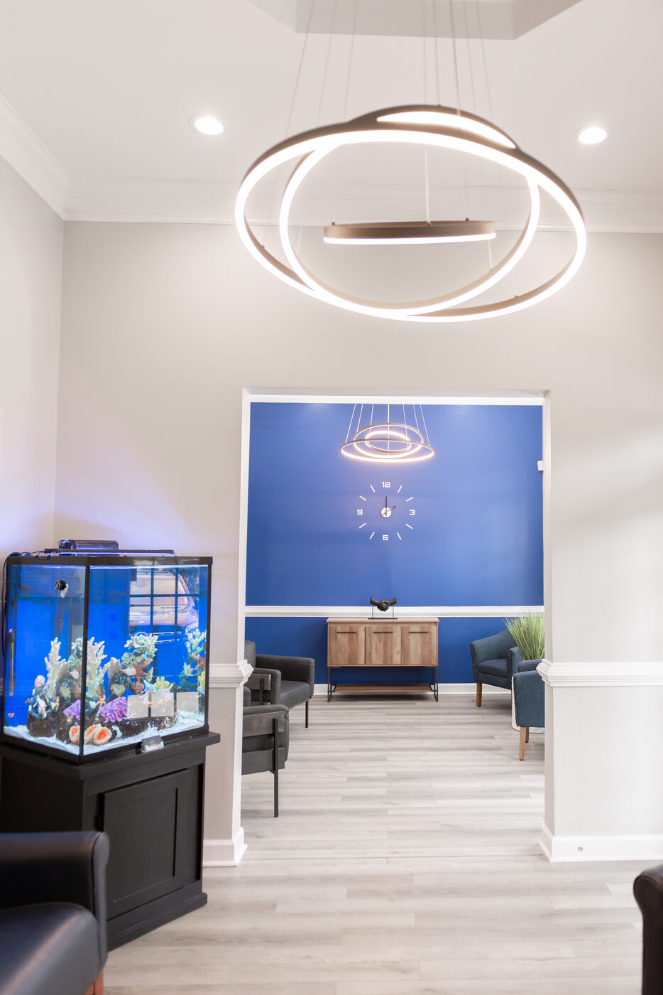 Reception area with large saltwater reef aquarium at THRIVE wellness clinic Alpharetta
